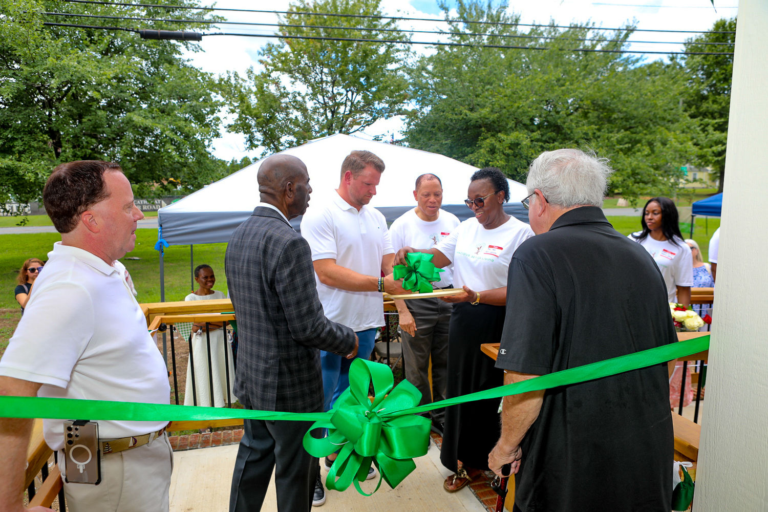 Community guests gathered beside the ribbon at the Gracious Senior Living grand opening